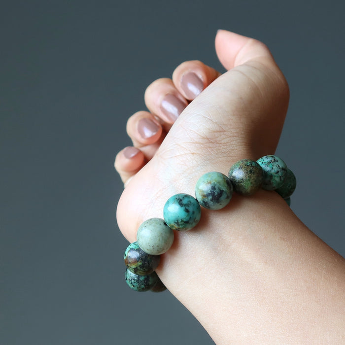 stretch beaded african turquoise bracelet on female model hand