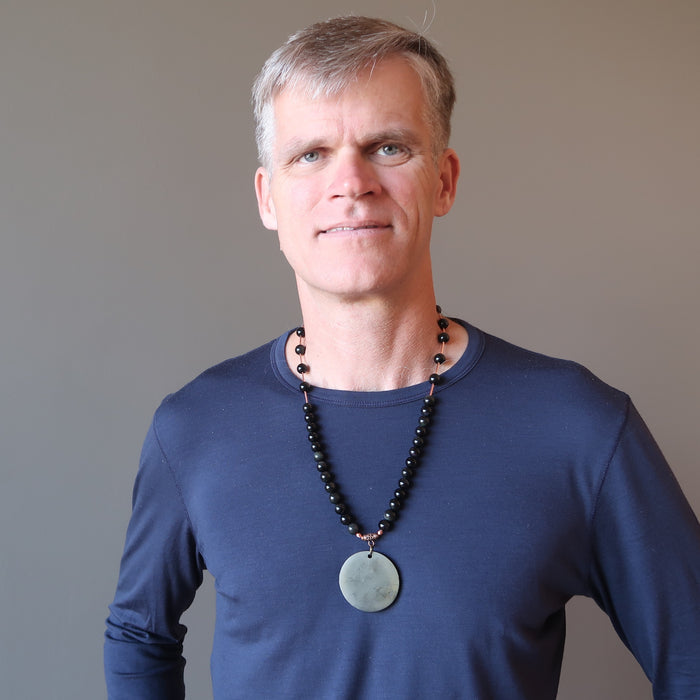 man wearing shungite rainbow obsidian necklace