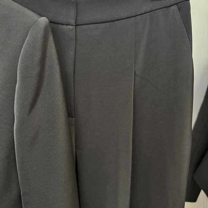 Close-up of tailored wide leg trousers suit for women in dark fabric showcasing sophisticated design