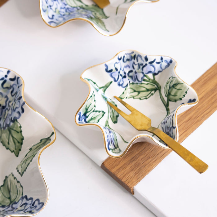 Adorn Blue Hydrangea Wavy Stoneware Bowl — Adorn bowl at a setting with separate utensils and patterned pottery; Susan Gordon Pottery