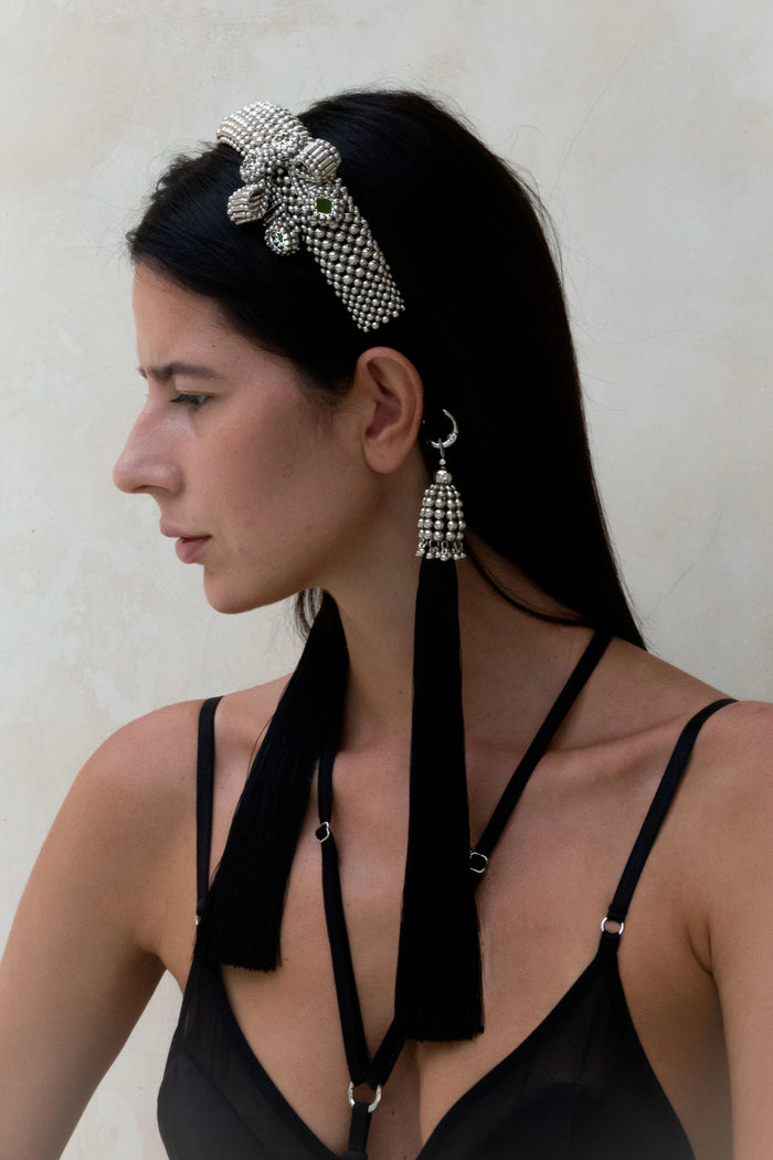 Woman in black outfit wearing Silver Beaded Amaya Headband with tassels by Object & Dawn in neutral background