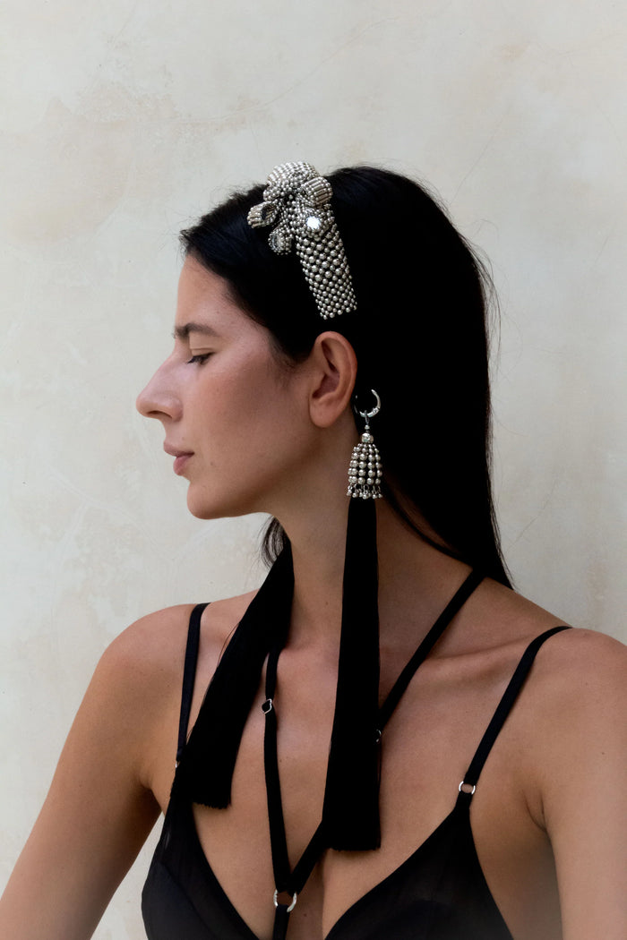 woman side picture wearing Amaya Bow Headband silver with 11" tassels silver-black by Object & Dawn