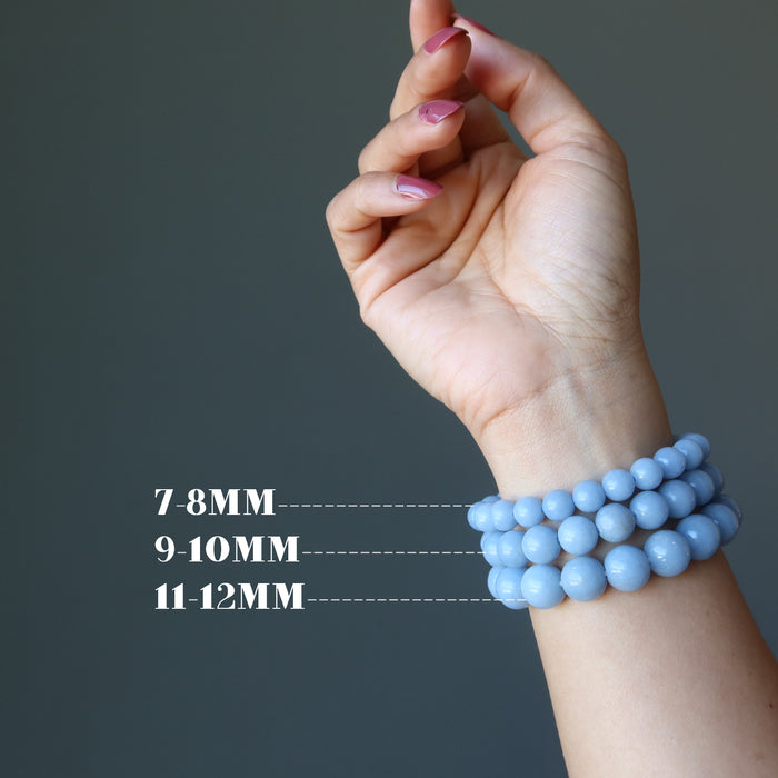 hand wearing 3 sizes of angelite stretch bracelets