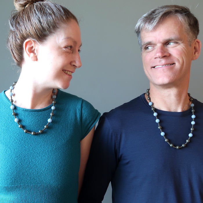 man and woman gazing at each other wearing pyrite and angelite beaded necklaces