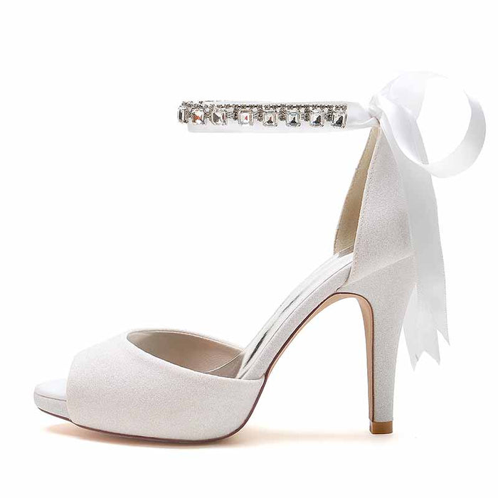 Elegant ankle strap bridal pumps with sparkling embellishments and ribbon for a stylish wedding look