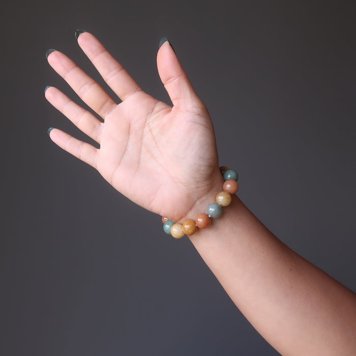 hand wearing multi colored aventurine stretch bracelet