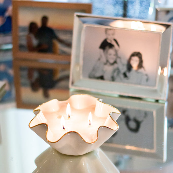 Bijou Soy Candle in Gold-Luster Stoneware — lit Bijou candle beside a separately sold picture frame; Susan Gordon Pottery