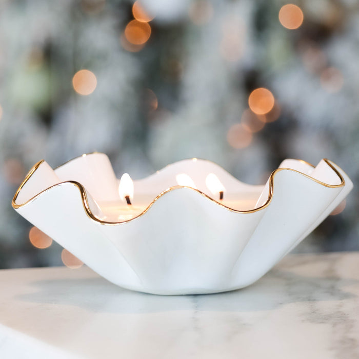 Bijou Soy Candle in Gold-Luster Stoneware — lit White candle showing its irregular wavy edge; Susan Gordon Pottery