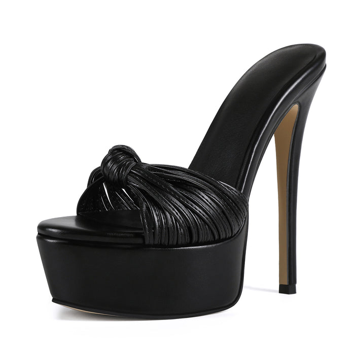 Black high-heeled platform mule sandal with a knotted upper design