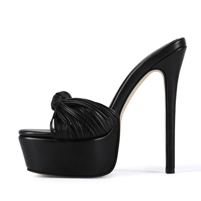 Stylish black leather-look platform stilettos with a statement knot front, shown in side view
