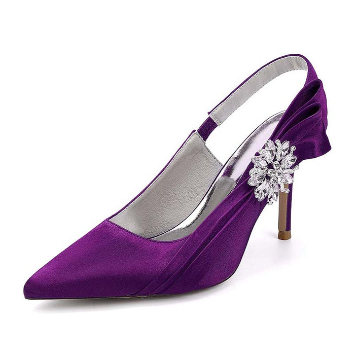 Purple high-heeled shoe with a decorative flower on a white background