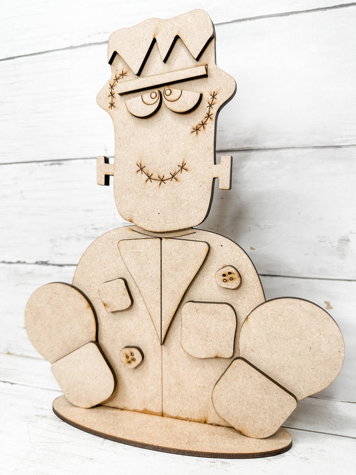 Assembled unfinished Frankenstein monster wooden shelf sitter DIY kit with layered jacket and shoes