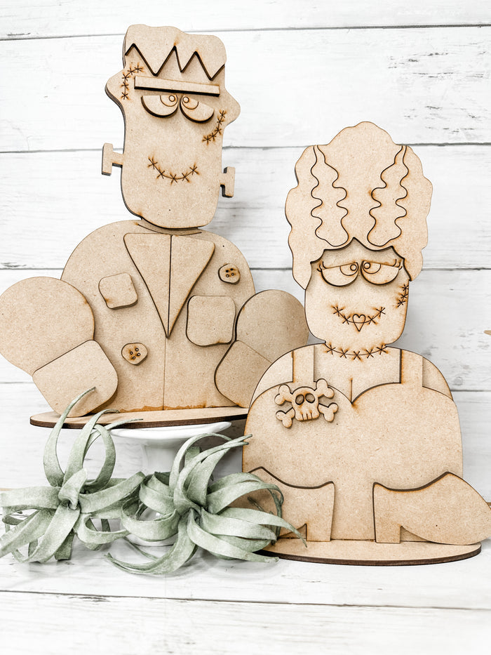 Unfinished Frankenstein and Bride of Frankenstein wooden Halloween craft kits assembled and displayed together