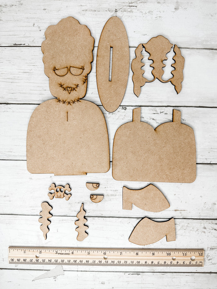 Unassembled Bride of Frankenstein wooden DIY kit pieces displayed with a ruler to show the finished size