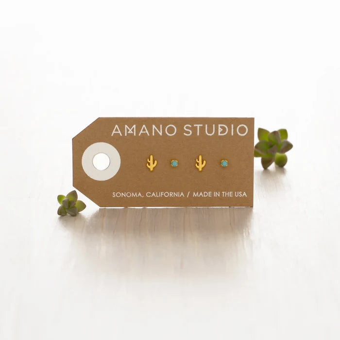 The pair of earrings shown on a card with the text "Amano studio", "Sonoma, California" and "Made in the USA" printed on the card and succulent plants in the background