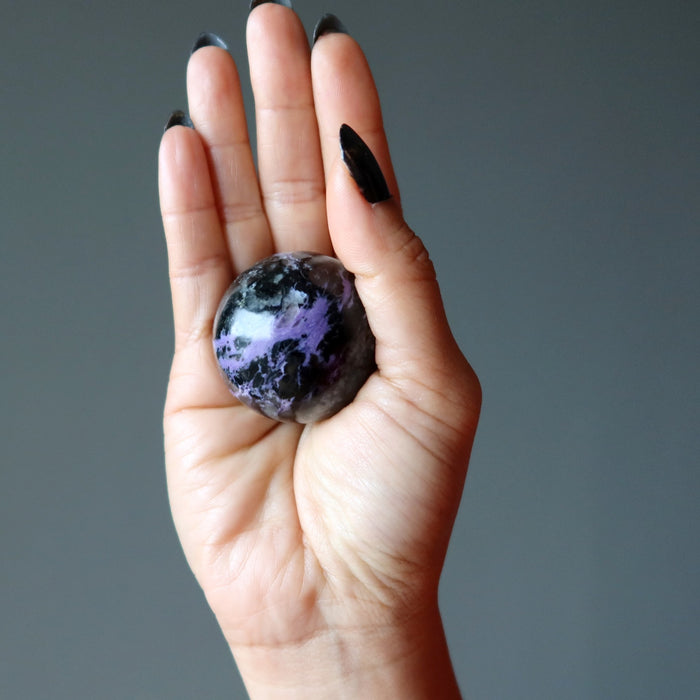 charoite sphere in hand