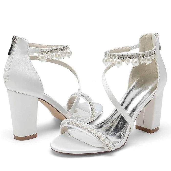 Elegant S&DCo. white heels with pearl embellishments, perfect shoes for wedding celebration
