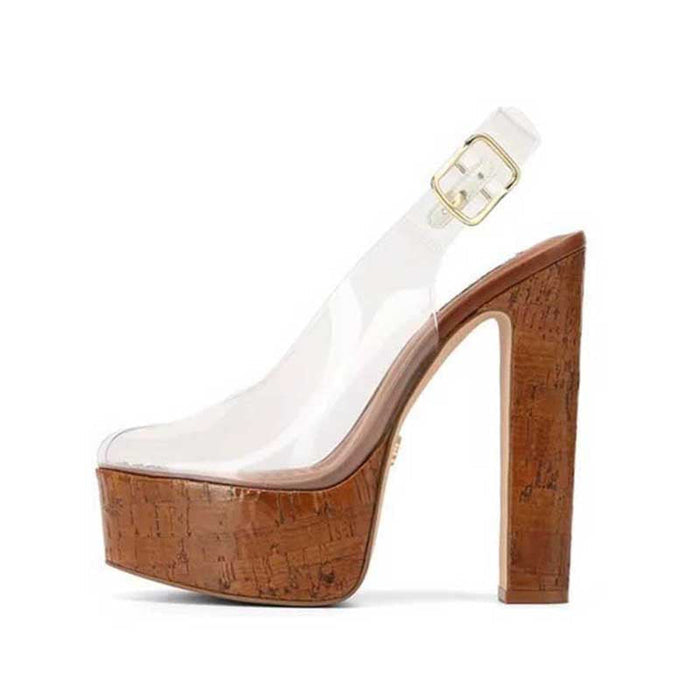 A single platform high heel shoe with a clear transparent upper and a thick brown cork-textured platform and block heel, featuring a clear ankle strap with a gold buckle, shown against a plain white background.