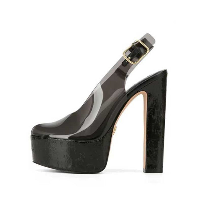 A single high-heeled slingback platform shoe in glossy black patent leather with a chunky block heel, a platform sole, and a clear upper section featuring a gold-tone buckle.