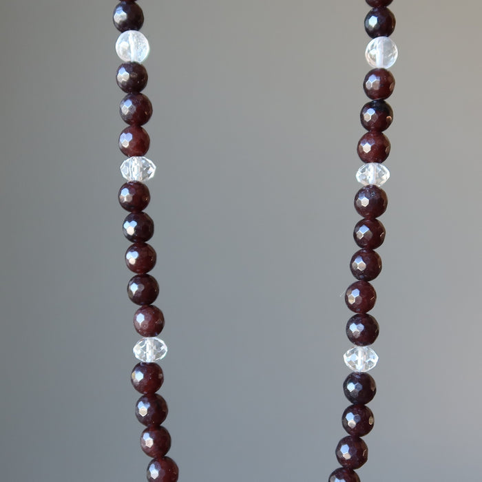 showing a middle part of clear quartz merkaba pendant on beaded faceted brown chalcedony necklace