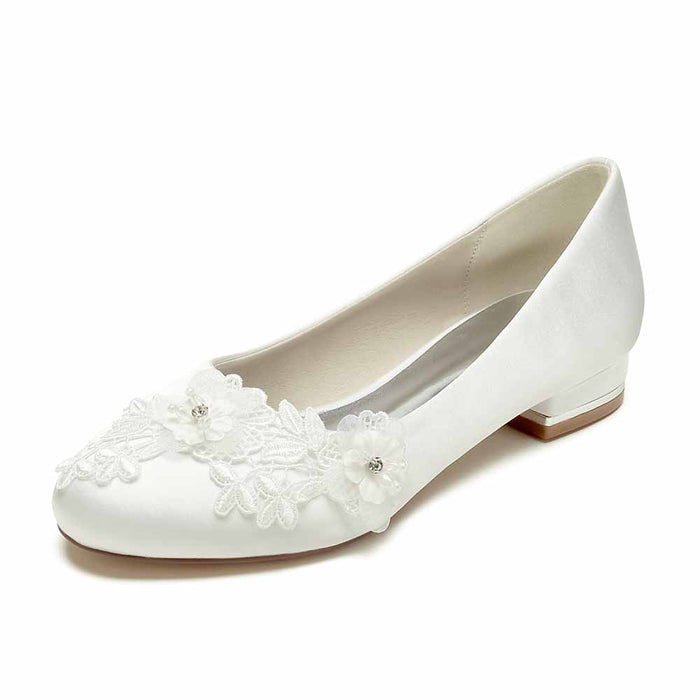 Elegant white comfortable wedding flats for bride with floral embellishments and a low heel
