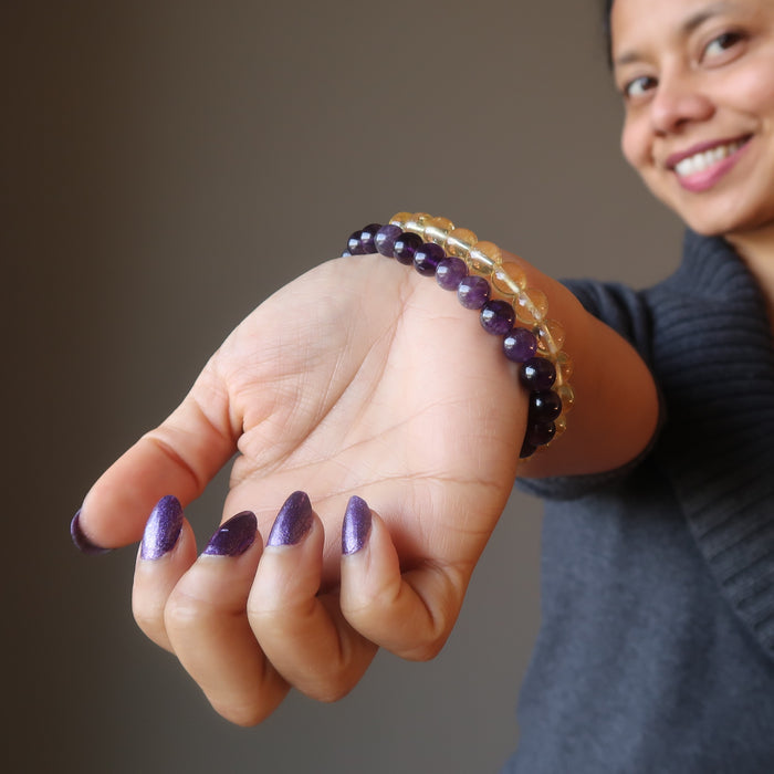 female modeling amethyst and citrine bracelet set