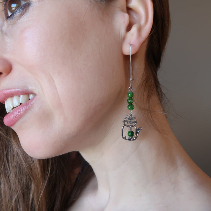 female model wearing sterling silver cat and green diopside gemstone earrings
