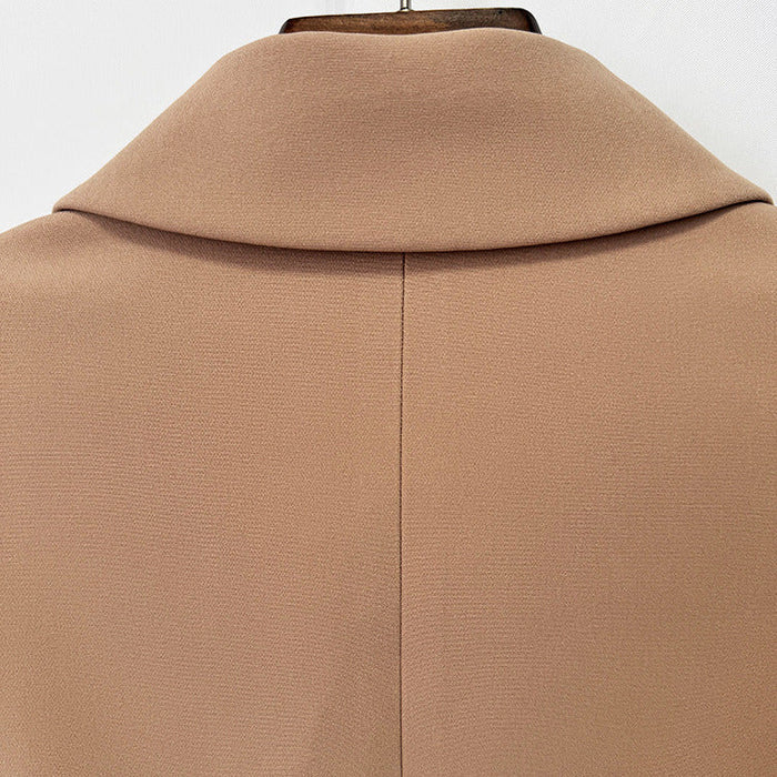 Close-up of the back of a camel-colored coat or jacket on a hanger, showing a high folded collar and a central seam.