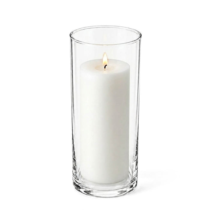 Clear 3.25"x9" cylinder vase with a lit white pillar candle