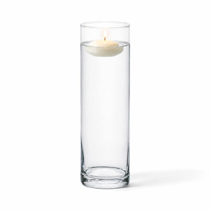 A 4"x13" clear glass cylinder vase containing a burning floating candle