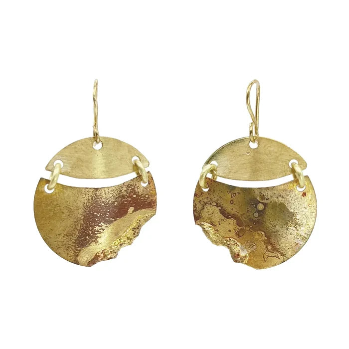 Pair of Sibilia Eclipse Lunar Earrings in Atacama, featuring a smooth matte gold half-disc top connected by gold jump rings to a larger raw-edged full disc with a warm gold and brown Atacama oxide patina finish, on gold wire hooks, on a white background