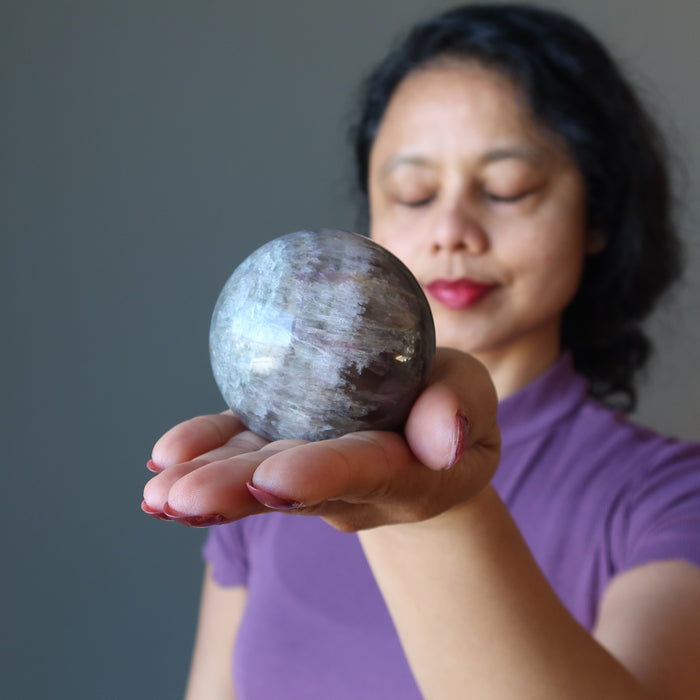 meditating on purple rainbow Fluorite Sphere