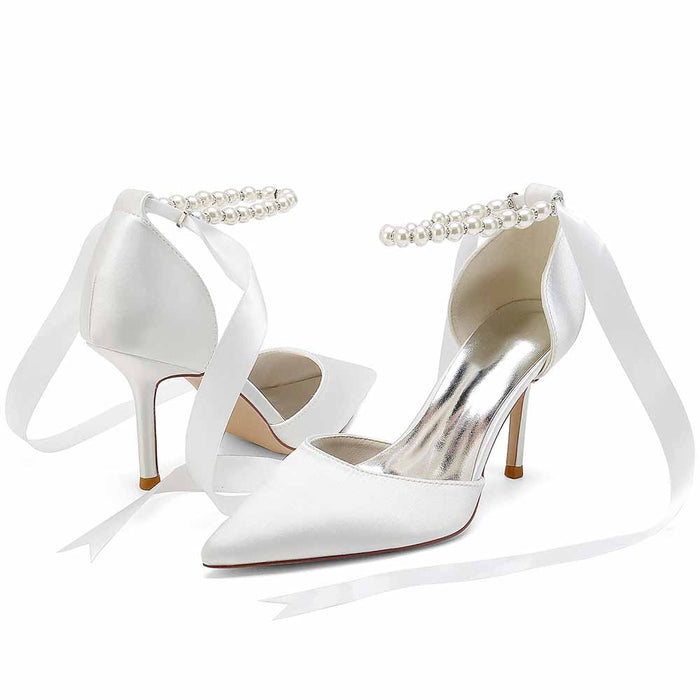 Elegant white heels with pearl ankle straps and satin ribbons, perfect shoes for the wedding