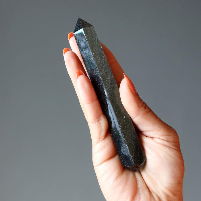 hand holding Faceted Gold Sheen Obsidian Wand