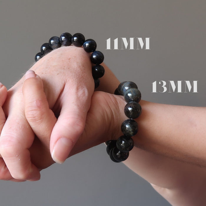 hands wearing an 11mm and 13mm hawks eye beaded bracelet