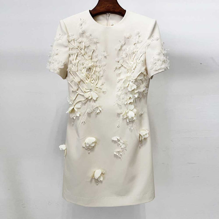 White dress with floral embellishments on a white background