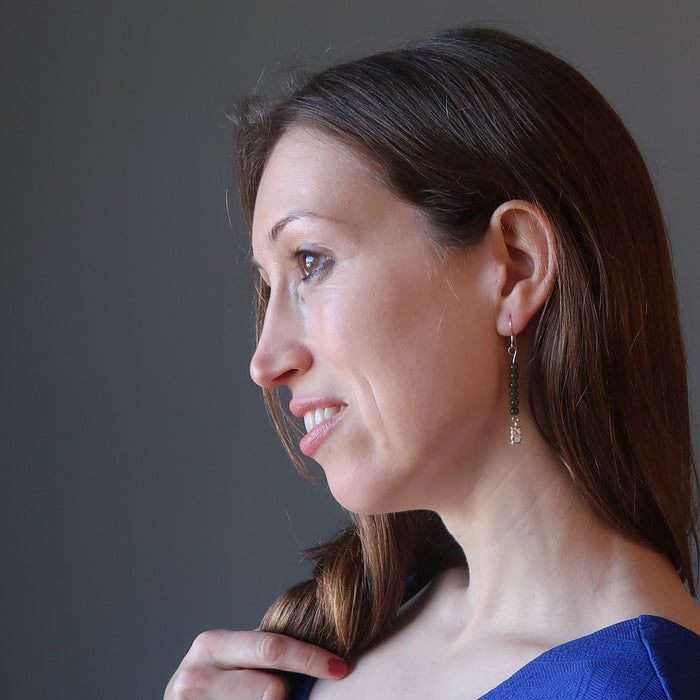 woman modeling jade owl earrings