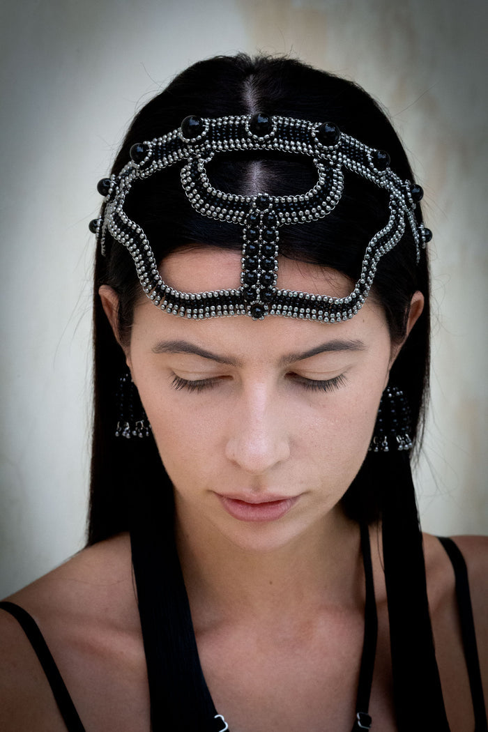 woman with black hair wearing modular beaded headband black in neutral background