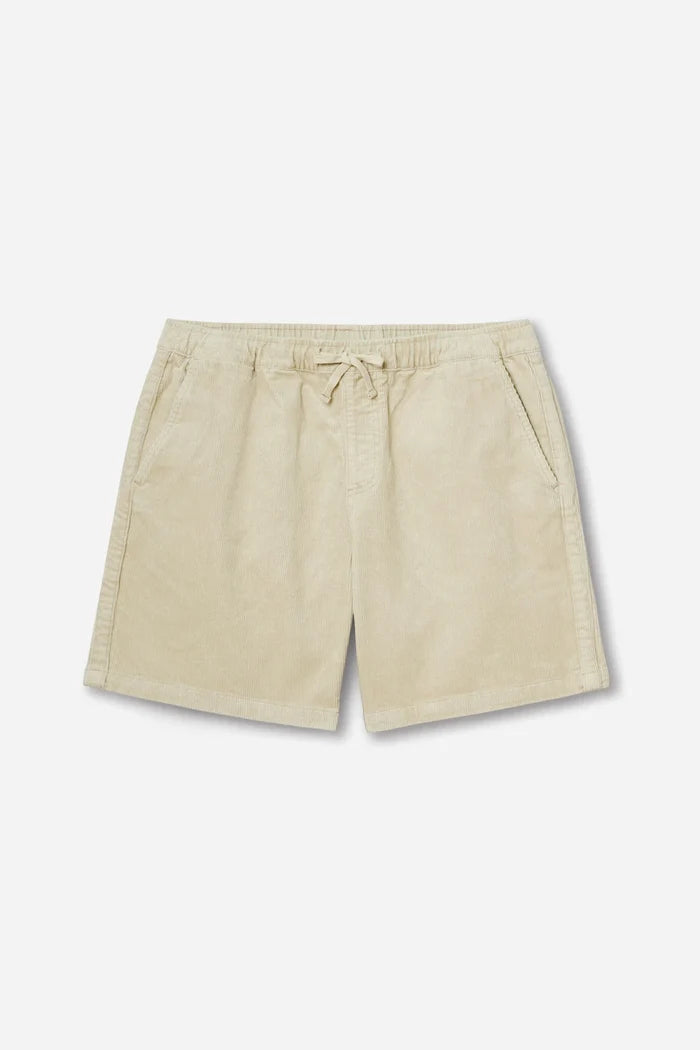 Katin Kord Patio Shorts in Pelican — flat lay front view showing the elastic waistband with external drawcord, faux fly, front slash pockets, and relaxed 18" outseam in pale cream stretch corduroy, on a light grey background