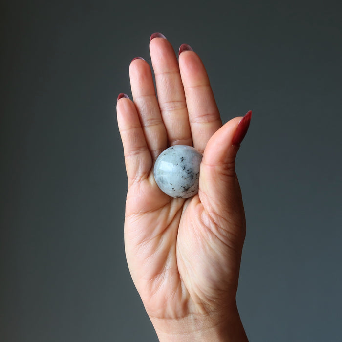 labradorite sphere in palm