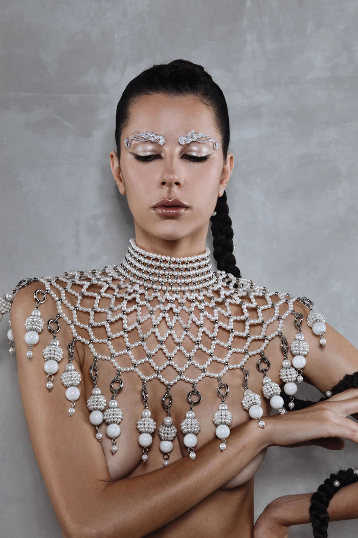 handcrafted large pearl medallion on freja modular cape by object and dawn