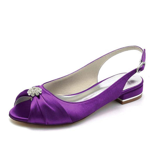 Purple satin shoe with a small embellishment on a white background