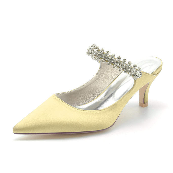 Yellow high-heeled shoe with crystal embellishments on a white background