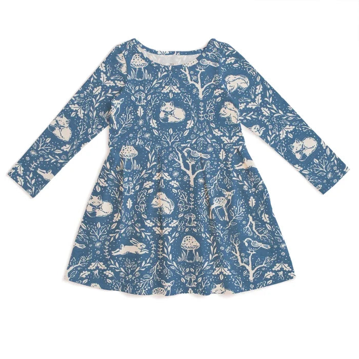 A long-sleeve blue dress with a white woodland print featuring rabbits, deer, mushrooms, and birds, shown flat against a white background.