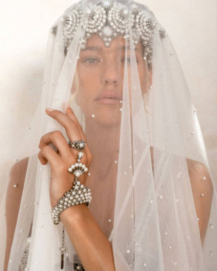 A blond bride is wearing a sheer veil over the Eingana Crown and pearl bracelet & ring combo by Object & Dawn.