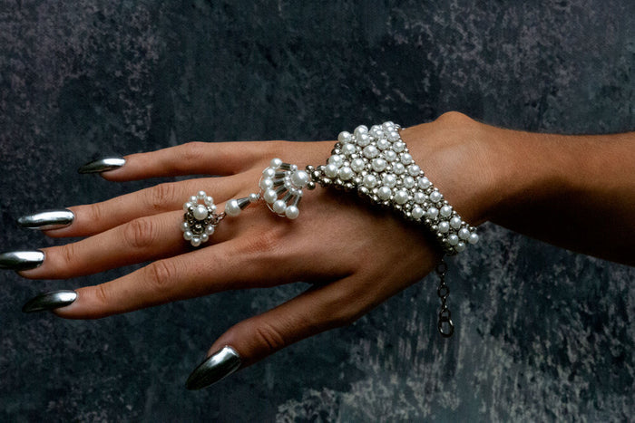 front view of model wearing Mata Hari Ring and jewery pearl and silver beads embellishments
