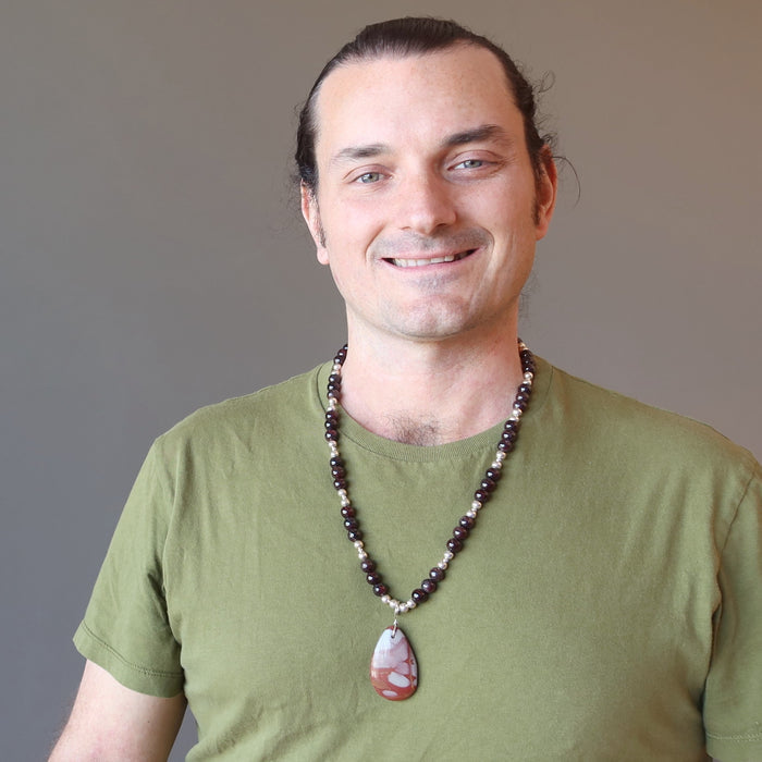 male wearing mookaite jasper and red garnet beaded necklace