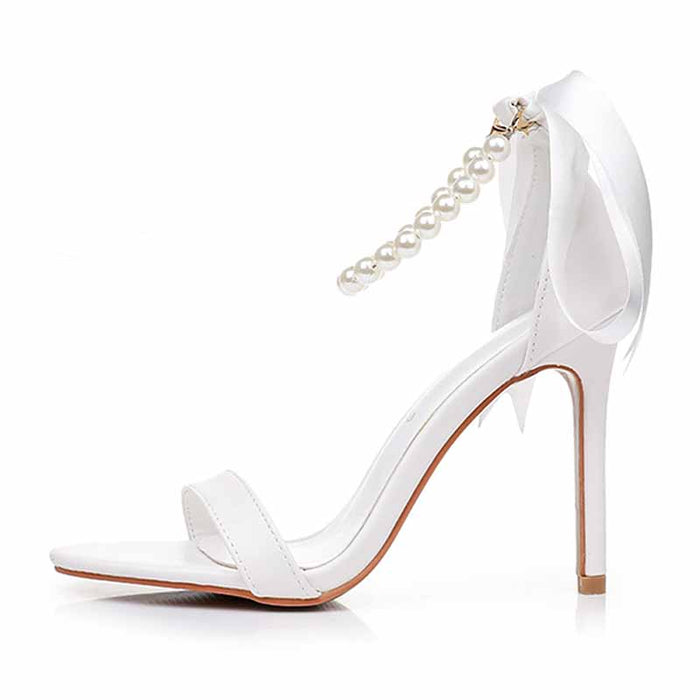 Elegant S&DCo. pearl bridal heels with a stylish pearl chain and a high stiletto heel