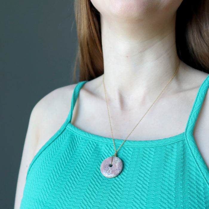 female model wearing pink jasper donut necklace
