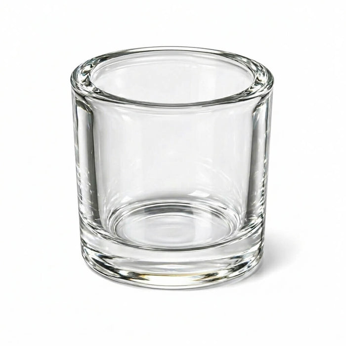 Clear glass cylindrical candle holder with thick base on white background